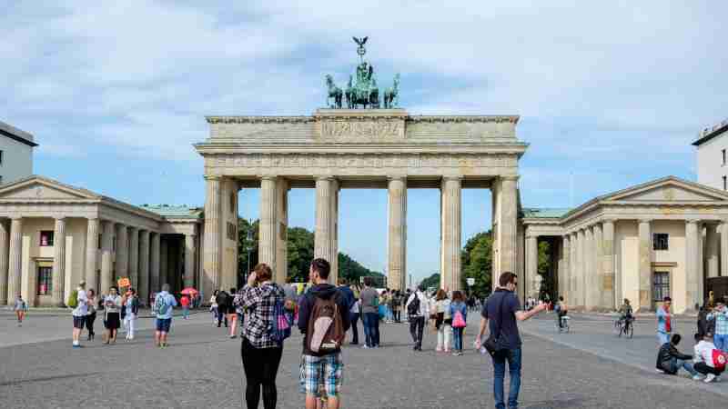 Visitors explore the iconic Brandenburg Gate in Berlin, Germany., tags: berliner und - pexel
