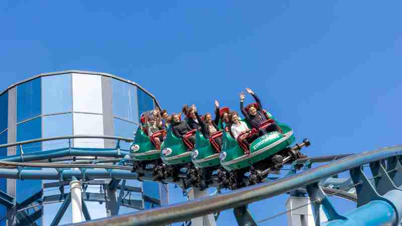 People enjoying a thrilling rollercoaster ride at Europa-Park under a clear blue sky., tags: 14 - pexel